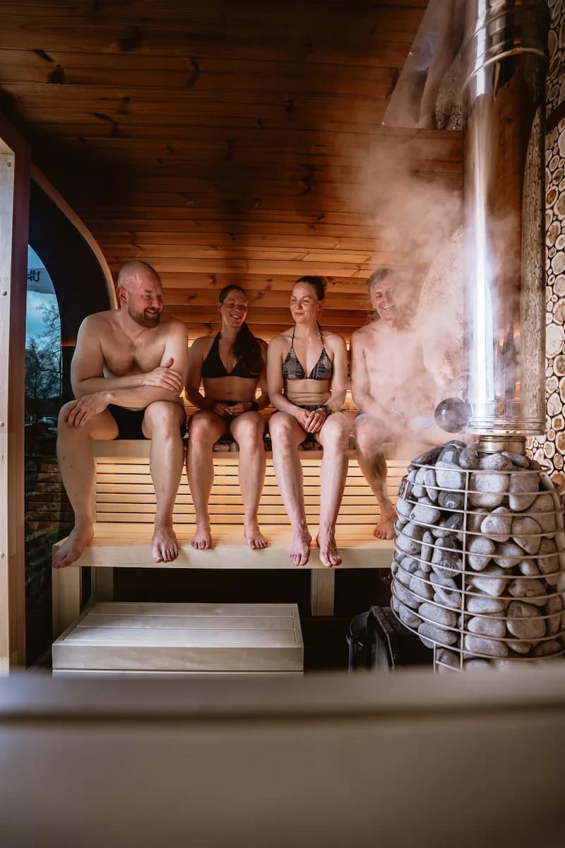 A group socializing together inside the sauna